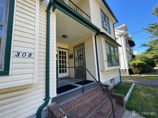 a view of a white house with a large windows