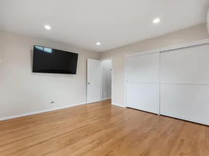 a view of a livingroom with an empty space and a flat screen tv