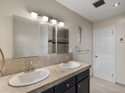 a bathroom with a sink double vanity and a mirror
