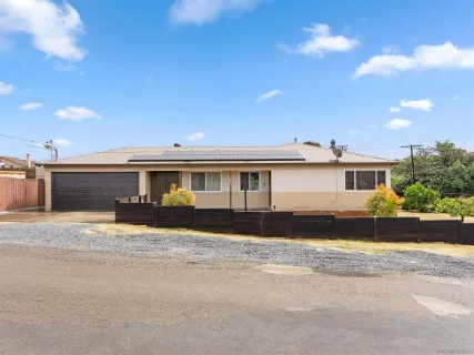 a front view of a house with a yard and a garage
