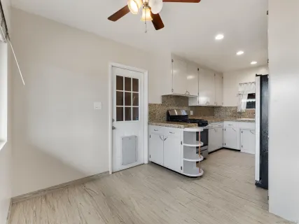 a kitchen with cabinets and window