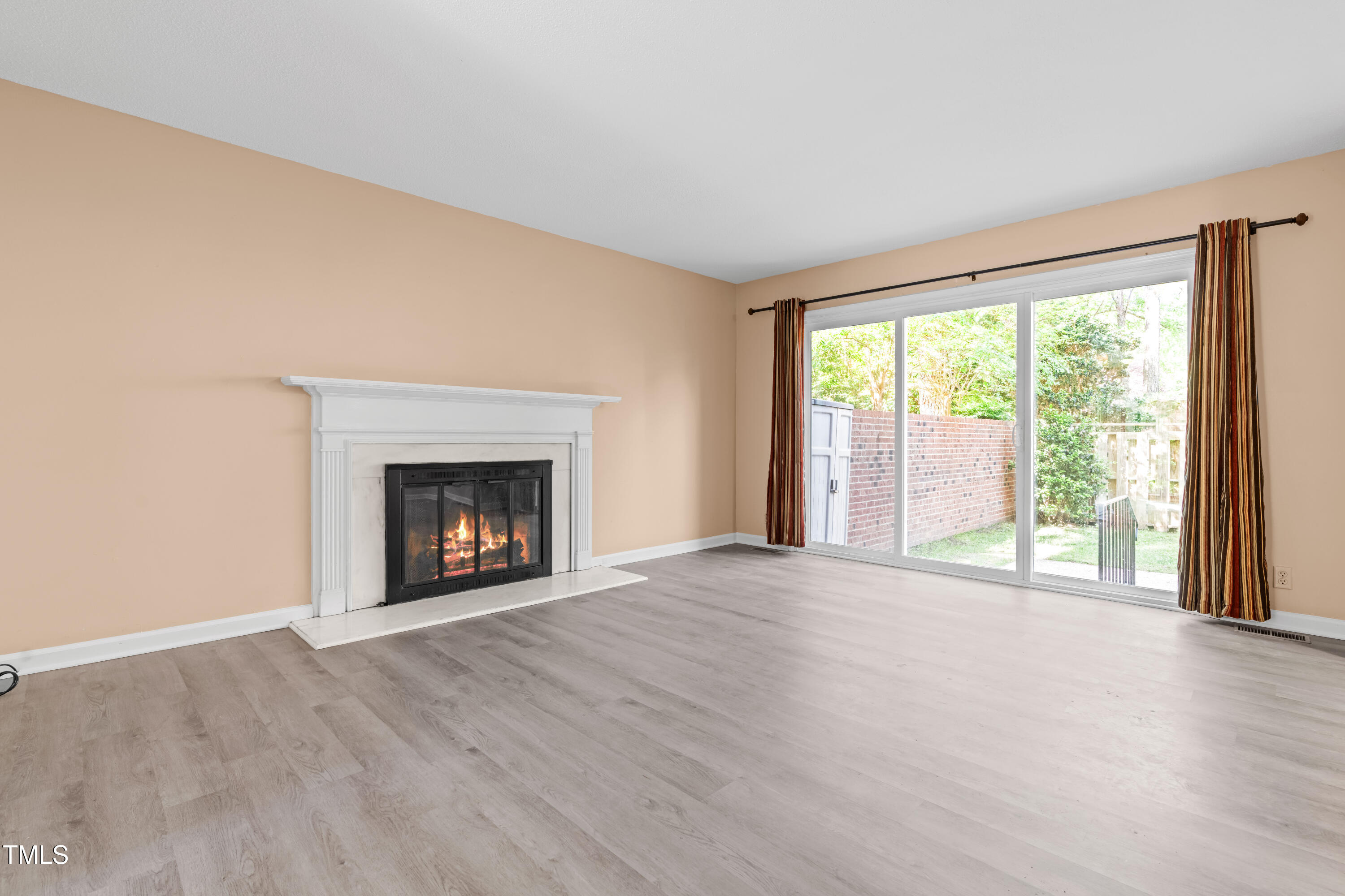 3029 Wycliff Road Raleigh, NC 27607 - Photo 12 of 35 a view of an empty room with a window and fireplace