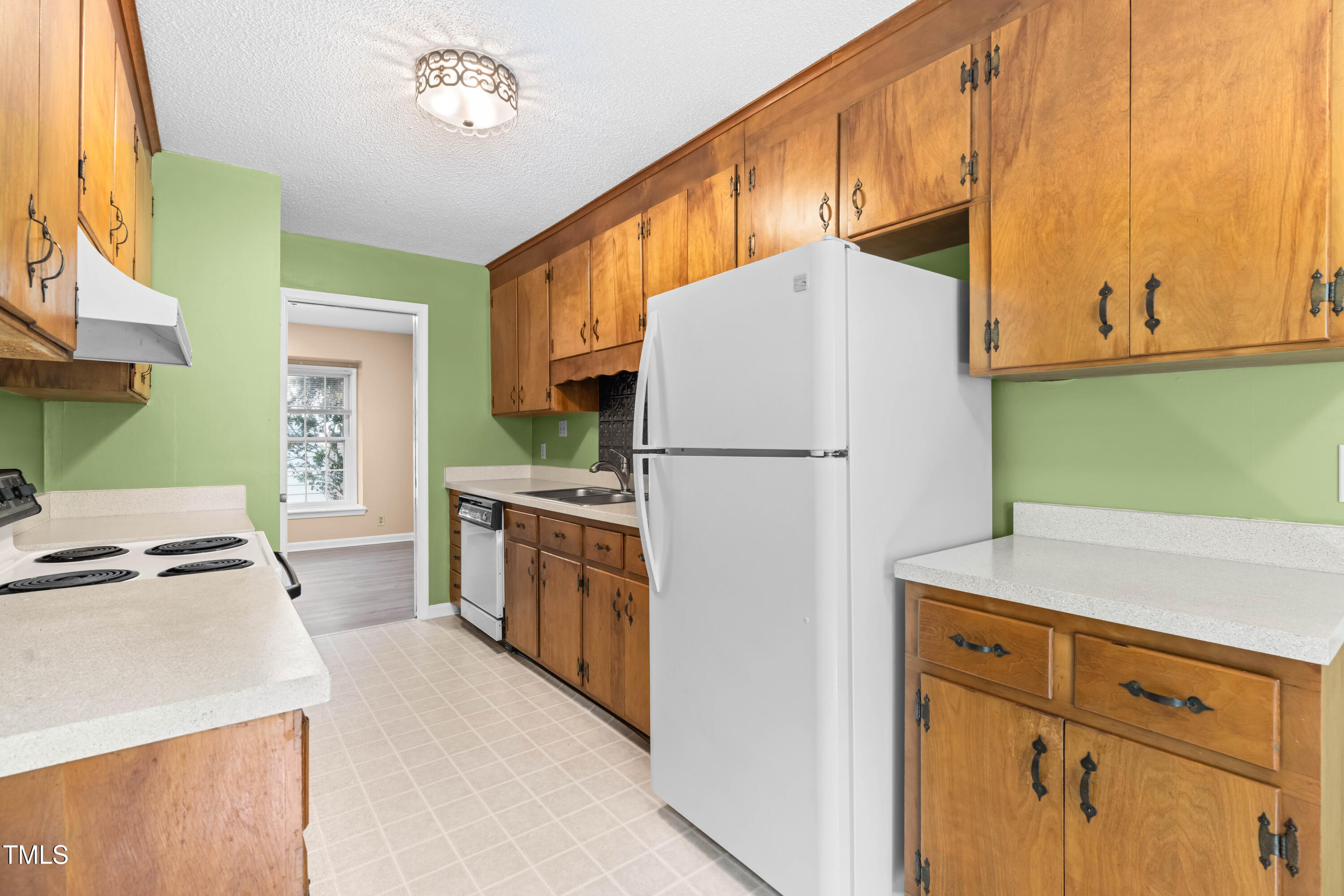 3029 Wycliff Road Raleigh, NC 27607 - Photo 14 of 35 a kitchen with cabinets a refrigerator and a stove