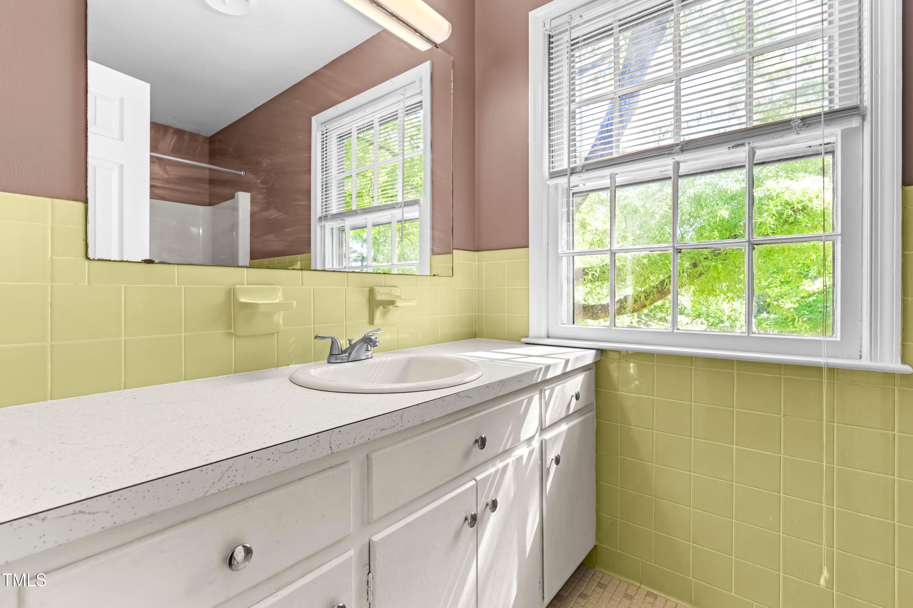 3029 Wycliff Road Raleigh, NC 27607 - Photo 19 of 35 a bathroom with a sink and a window