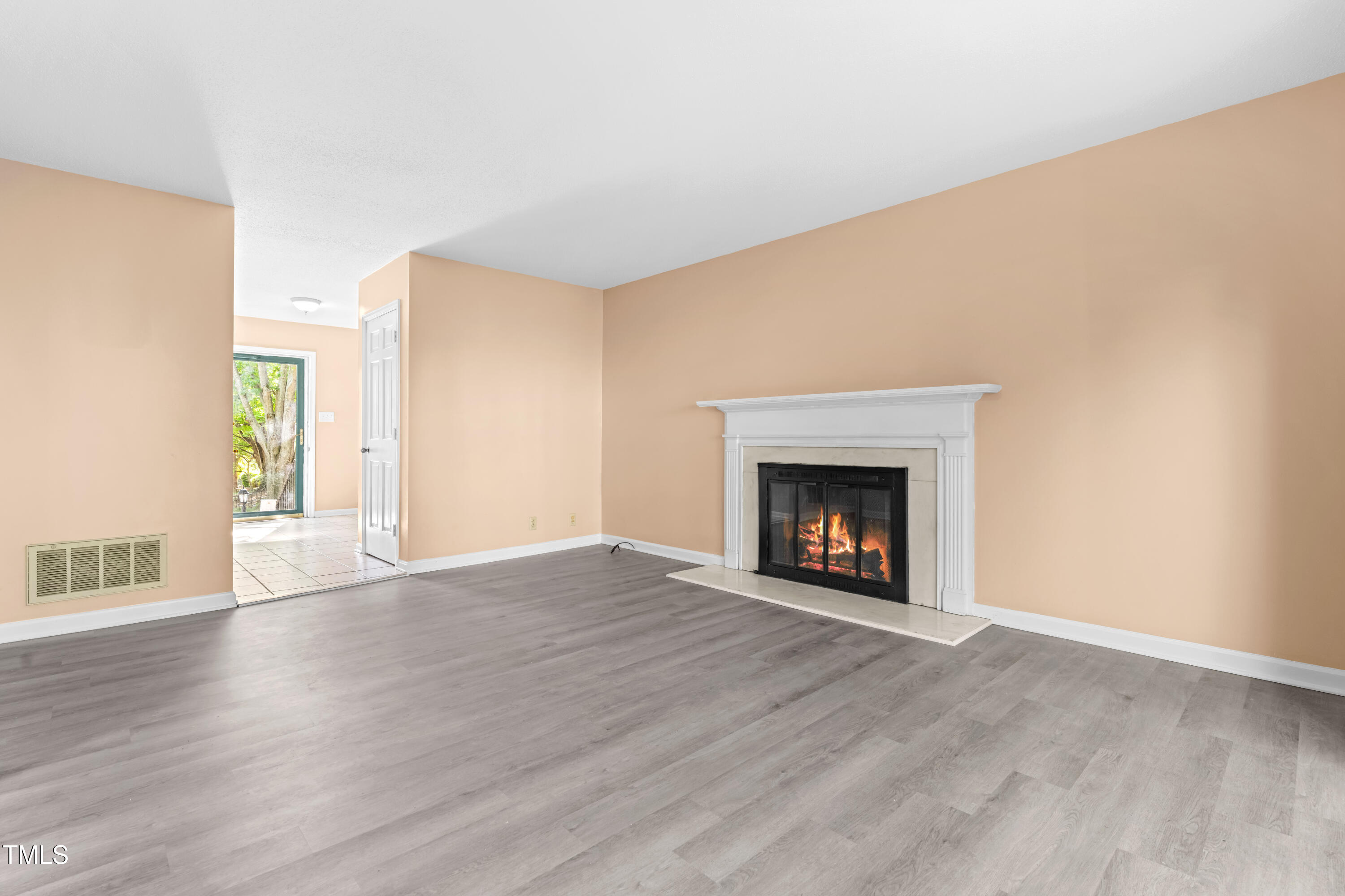 3029 Wycliff Road Raleigh, NC 27607 - Photo 9 of 35 a view of an empty room with a fireplace and a window