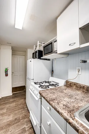 a kitchen with kitchen island granite countertop a sink and a stove