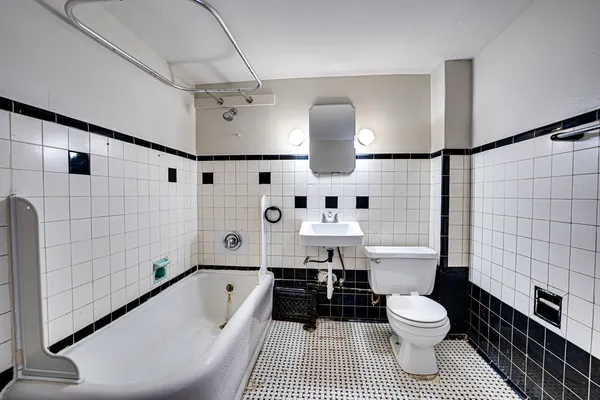 a bathroom with a toilet a sink and bathtub