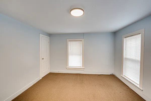 an empty room with a fan