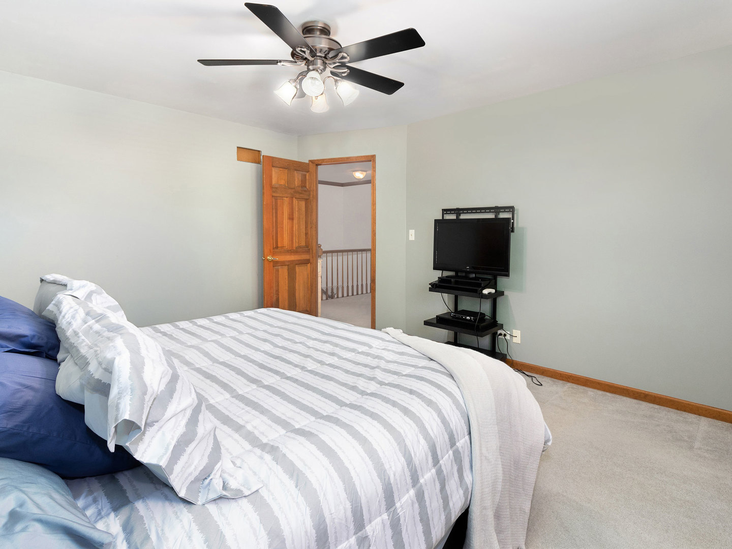 65 Briarcliff Road Montgomery, IL 60538 - Photo 22 of 34 a bedroom with a bed and a flat tv screen on a dresser