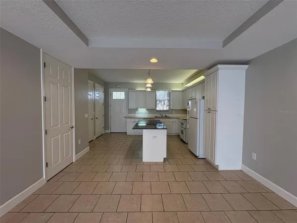 a kitchen with a refrigerator and a sink