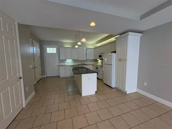 a kitchen with stainless steel appliances a refrigerator and a stove top oven