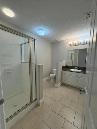 a bathroom with a sink a toilet and a shower