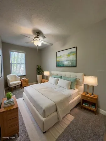 a spacious bedroom with a bed and window
