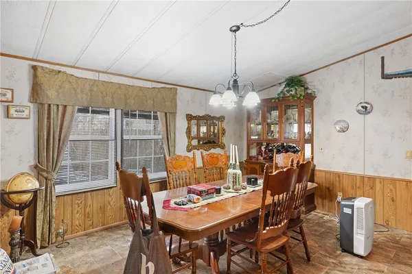 a view of a dining room with furniture window and outside view