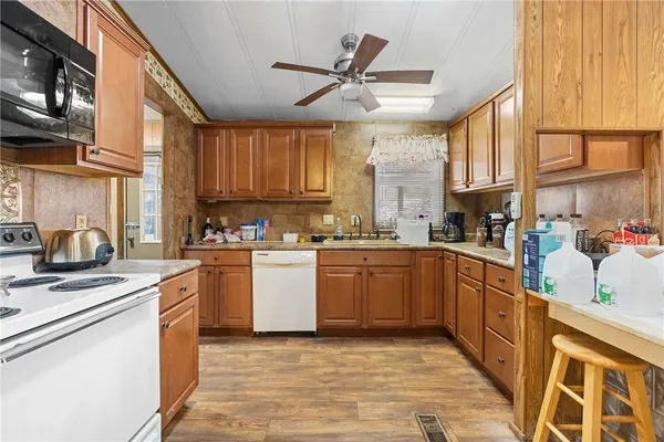 a kitchen with stainless steel appliances granite countertop a sink a stove and a refrigerator