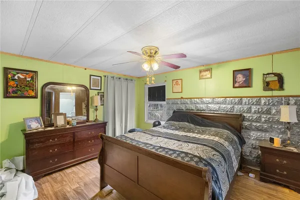 a bedroom with a bed and a chandelier
