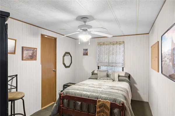 a bedroom with a bed mirror and a window