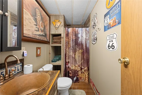 a white toilet sitting next to a bathroom sink