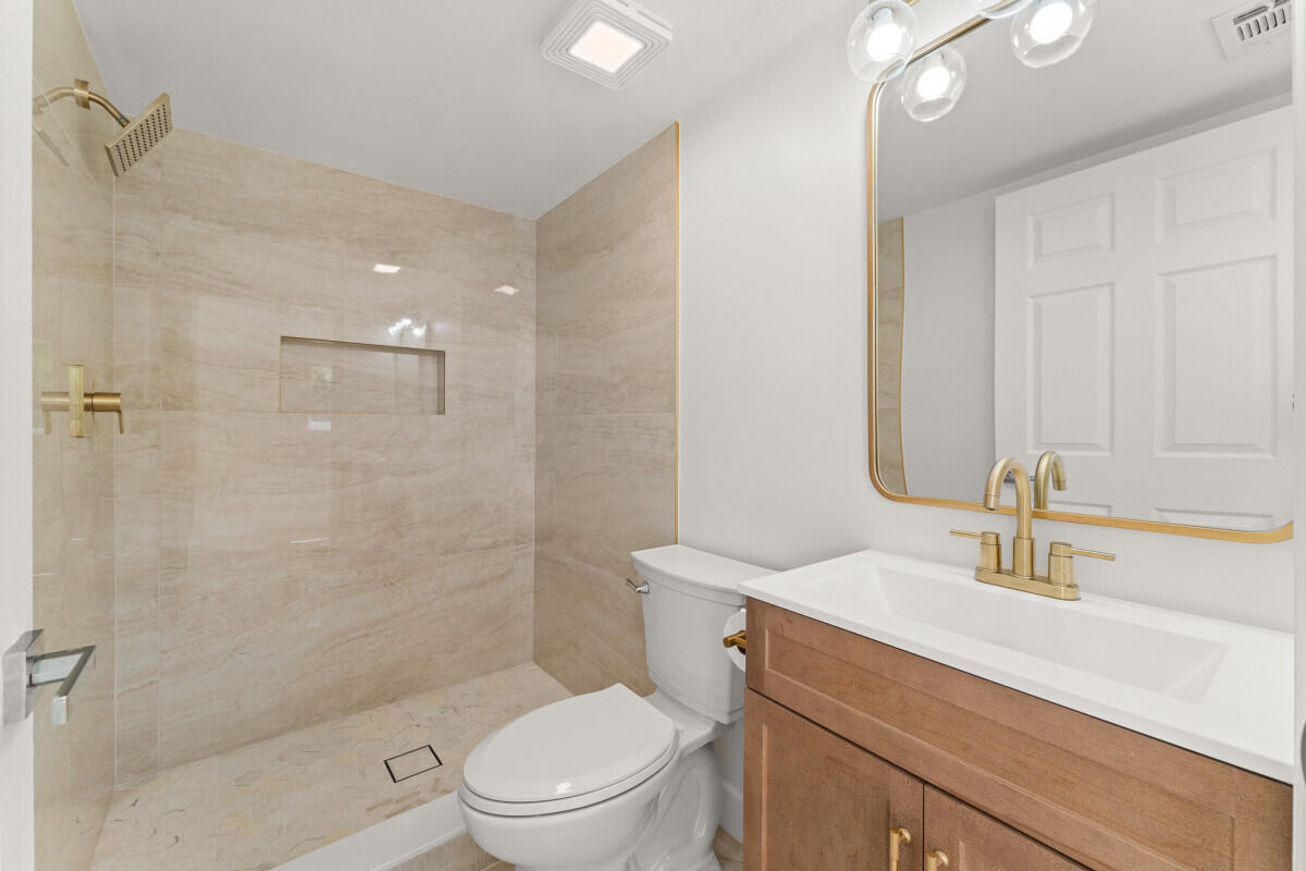 3797 Bahama Road Palm Beach Gardens, FL 33410 - Photo 10 of 33 a bathroom with a sink a toilet and shower