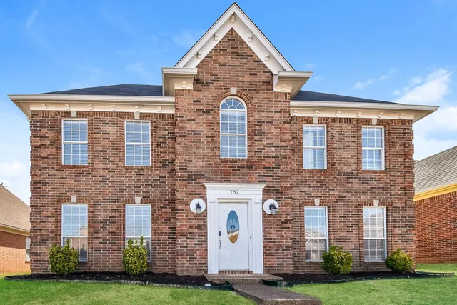 a front view of a building with garden