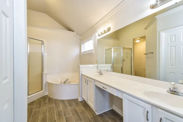 a bathroom with a tub sink and mirror