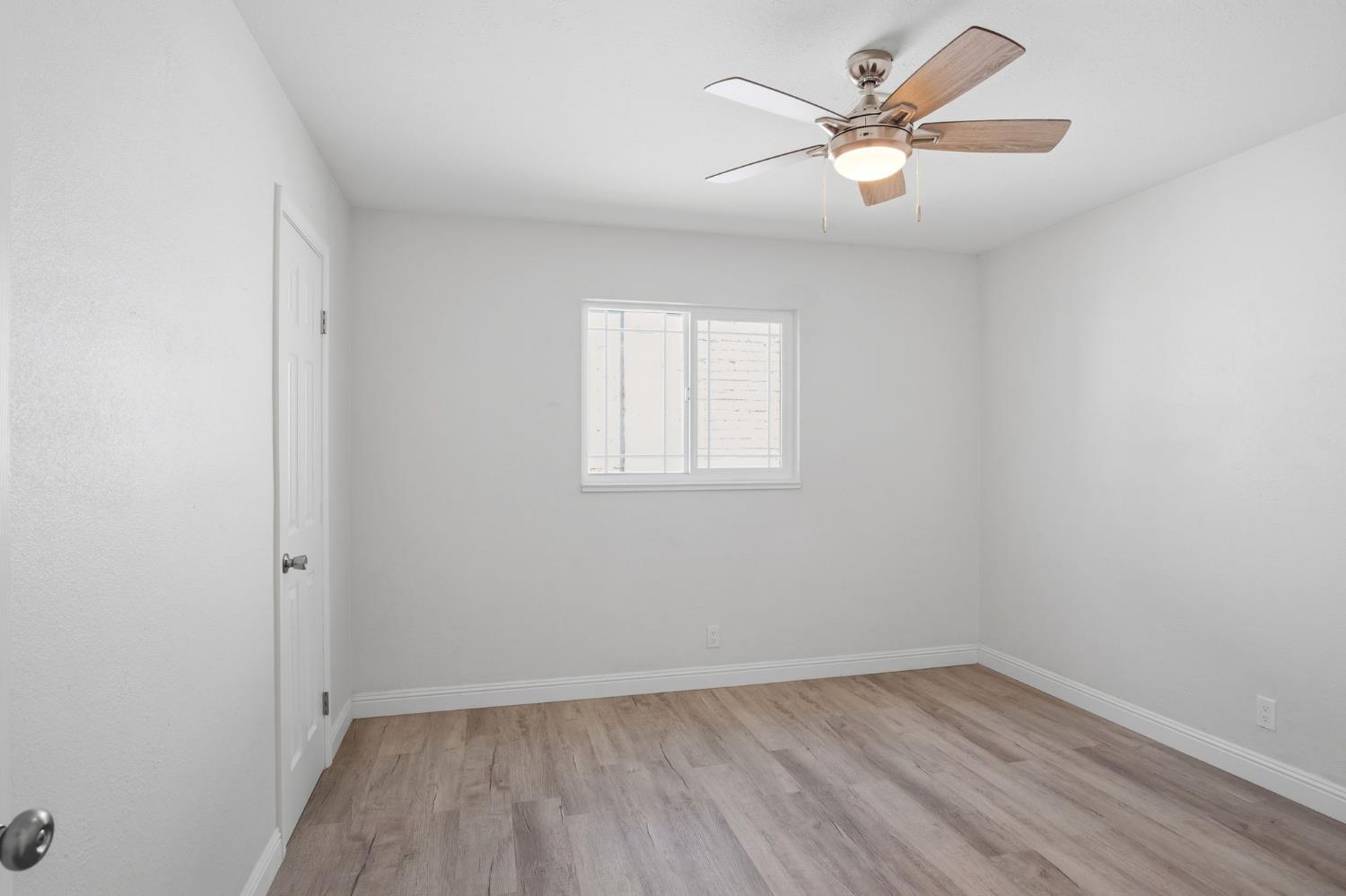 341 2nd Street Livingston, CA 95334 - Photo 16 of 19 an empty room with a window and a fan