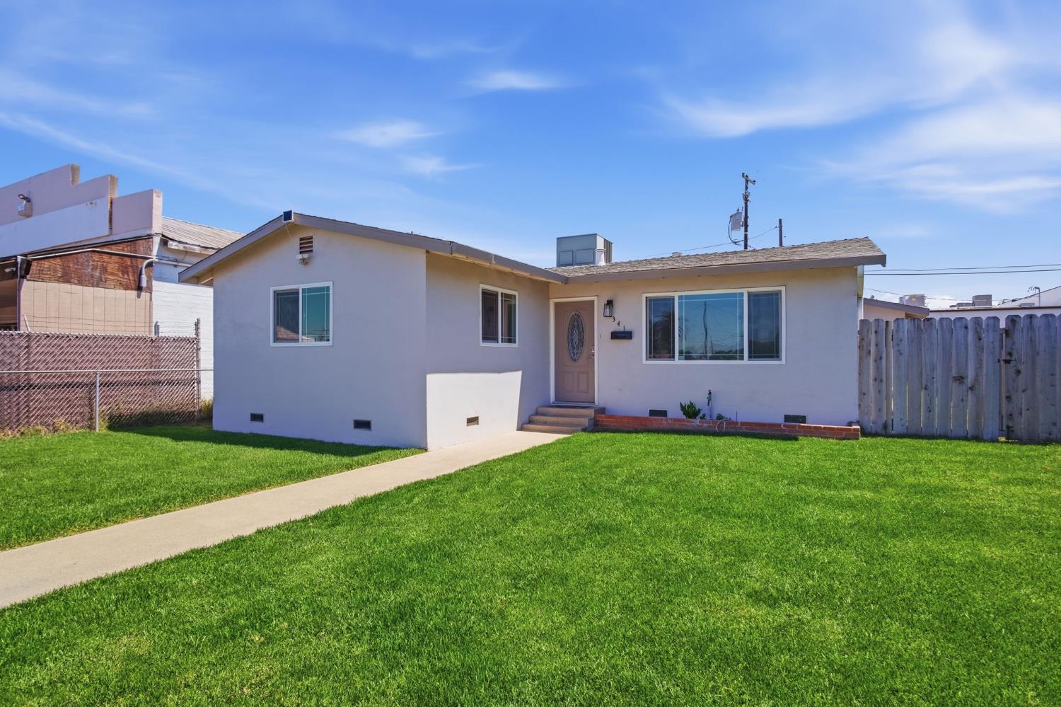 341 2nd Street Livingston, CA 95334 - Photo 2 of 19 a front view of a house with a yard