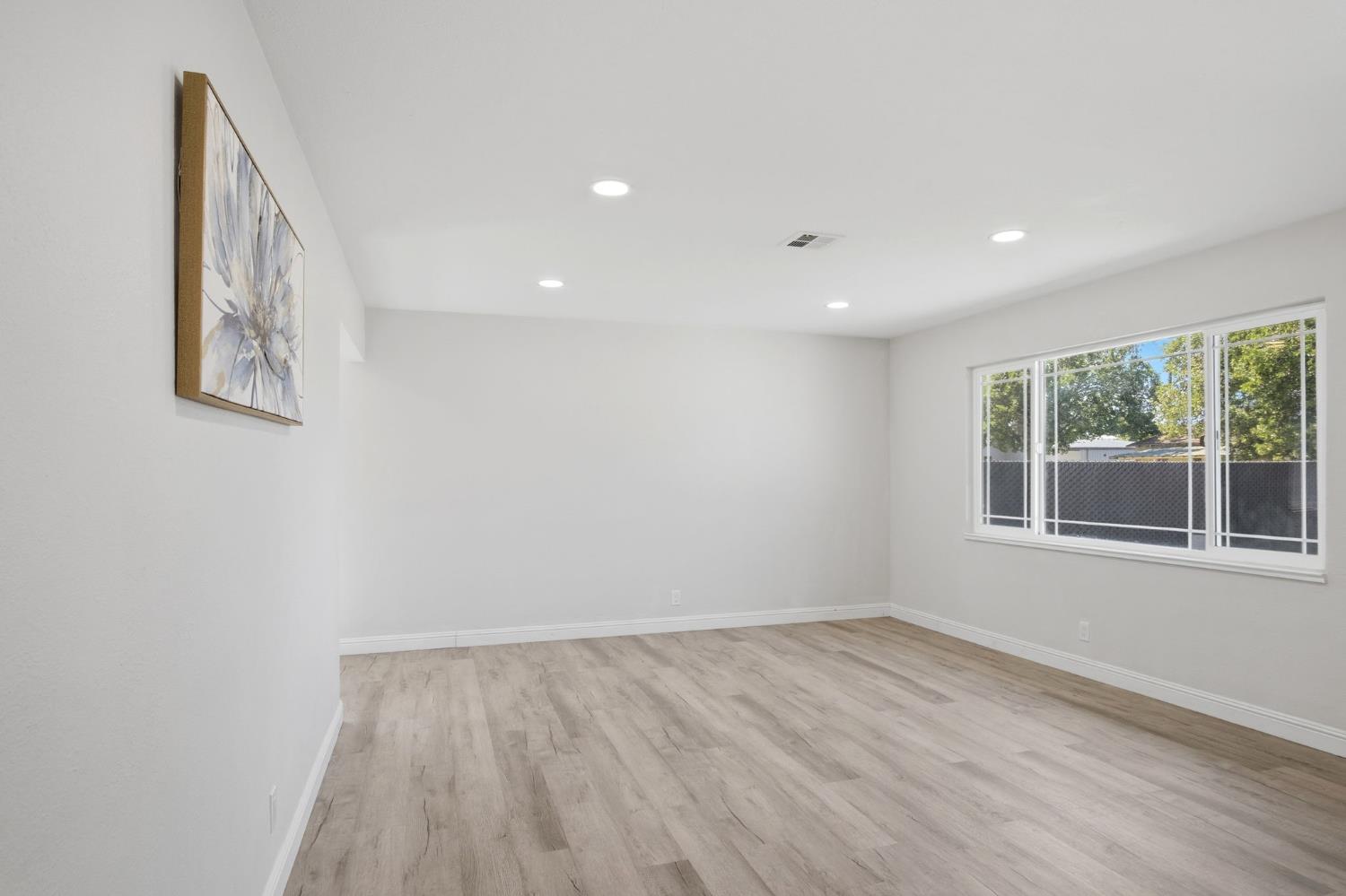 341 2nd Street Livingston, CA 95334 - Photo 5 of 19 an empty room with wooden floor and windows