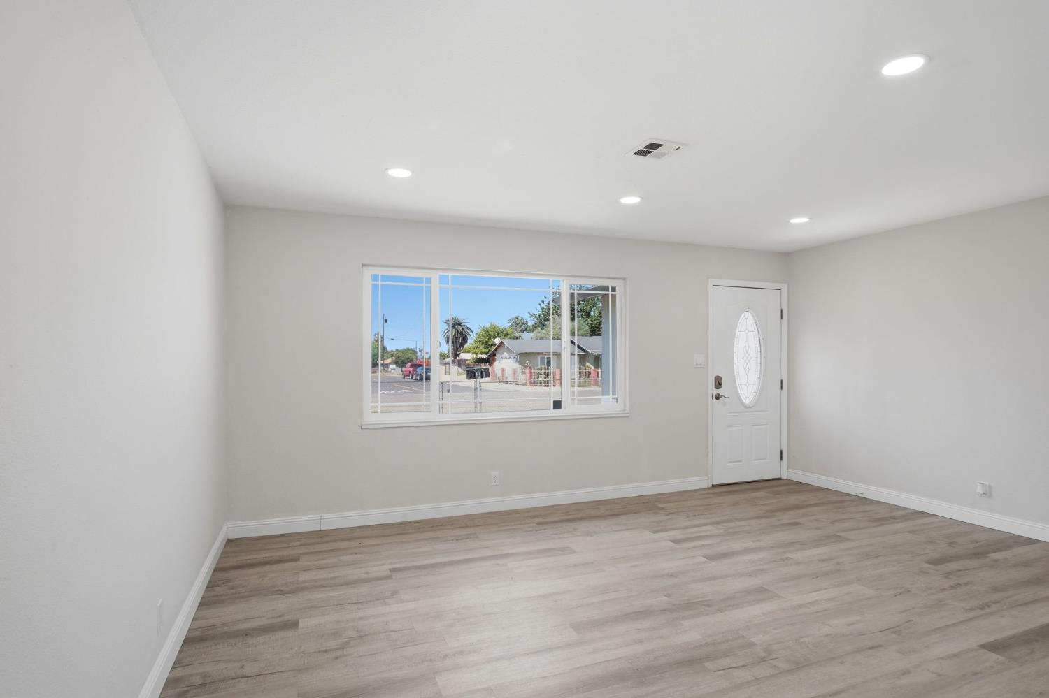 341 2nd Street Livingston, CA 95334 - Photo 6 of 19 an empty room with wooden floor and window