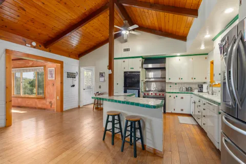 a kitchen with stainless steel appliances kitchen island granite countertop a stove and a sink