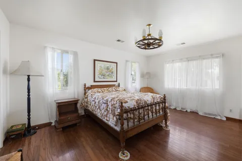 an aerial view of a house with a yard and a large tree