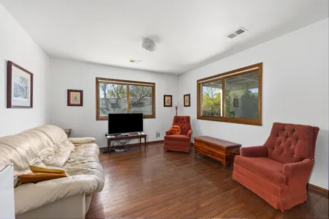 a white house that has a tree in front of it