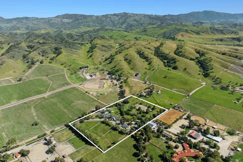a view of a lush green hillside and houses