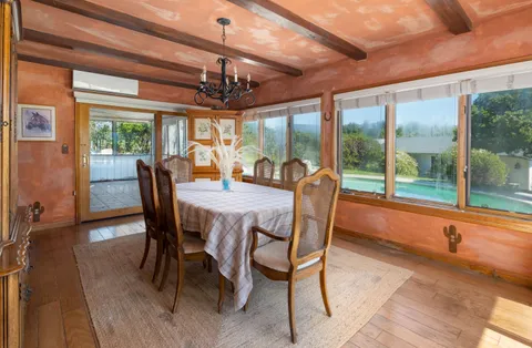 a kitchen with stainless steel appliances granite countertop a refrigerator a stove top oven a sink dishwasher and white cabinets with wooden floor