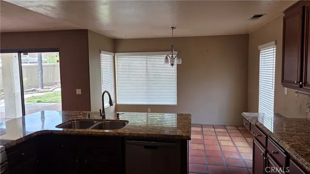 a kitchen with a sink and large windows