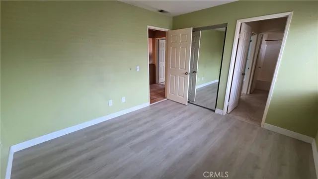 an empty room with wooden floor and a door