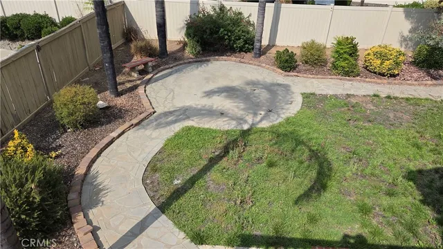 a view of a backyard with plants and a patio