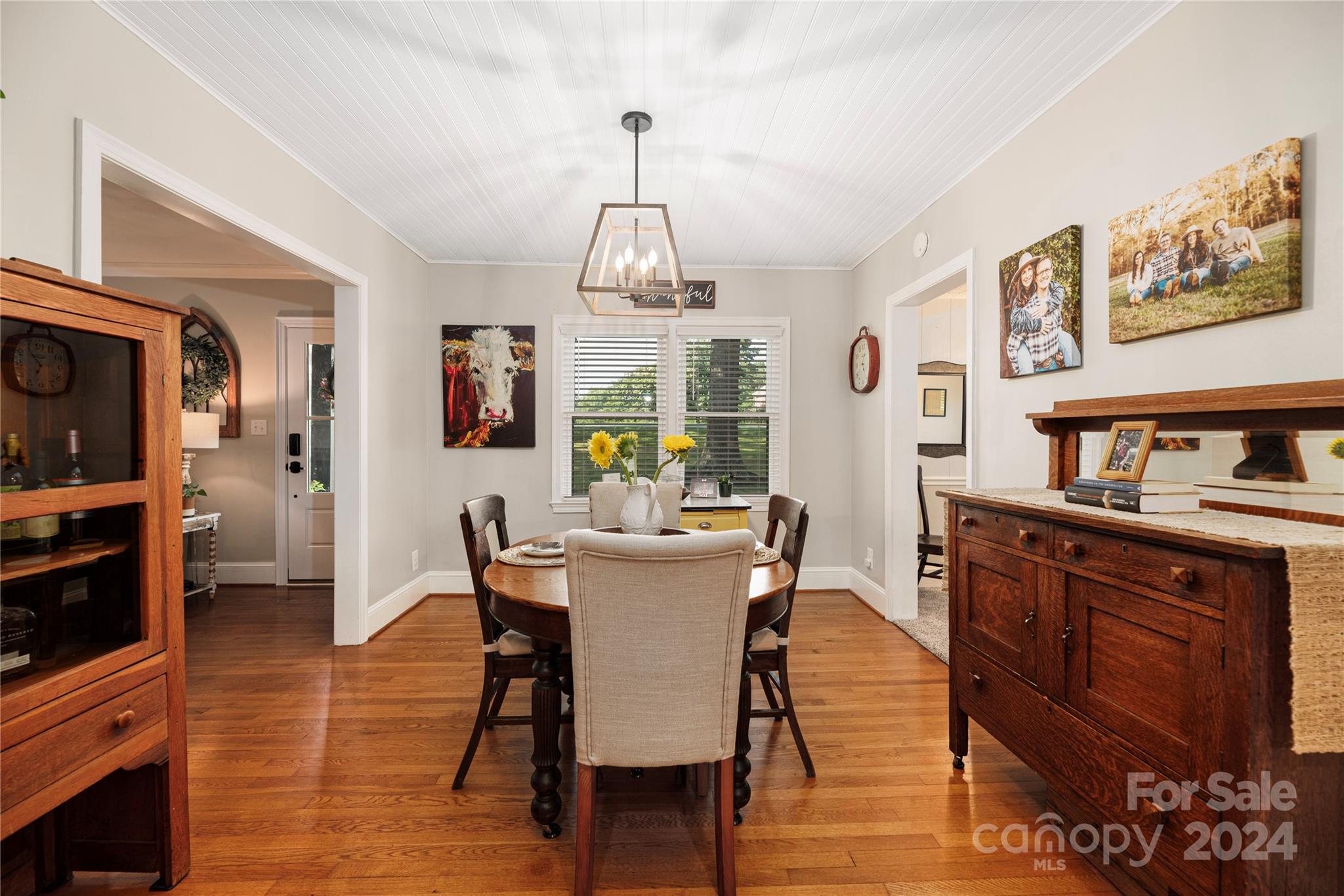 13002 Mayes Road Huntersville, NC 28078 - Photo 10 of 43 a view of a dining room with furniture window and wooden floor