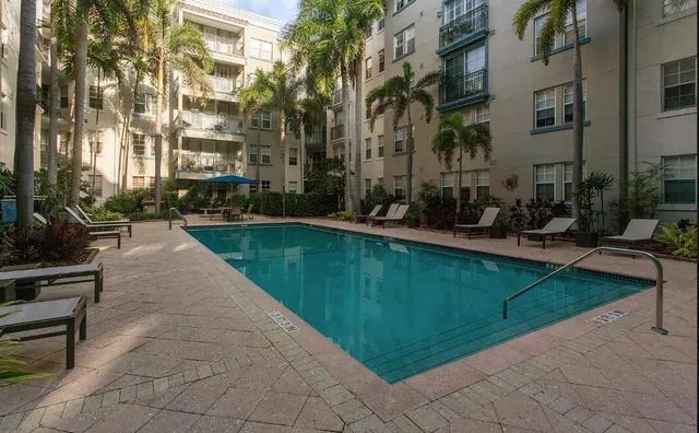 a patio with a table and chairs under an umbrella