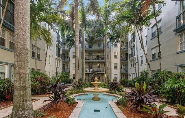a view of patio with table and chairs under an umbrella