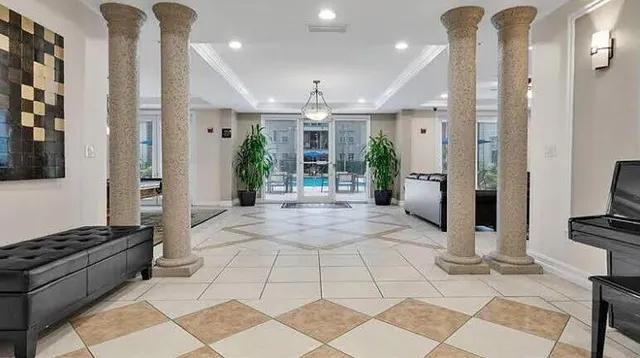 a view of a hallway with wooden floor and a living room
