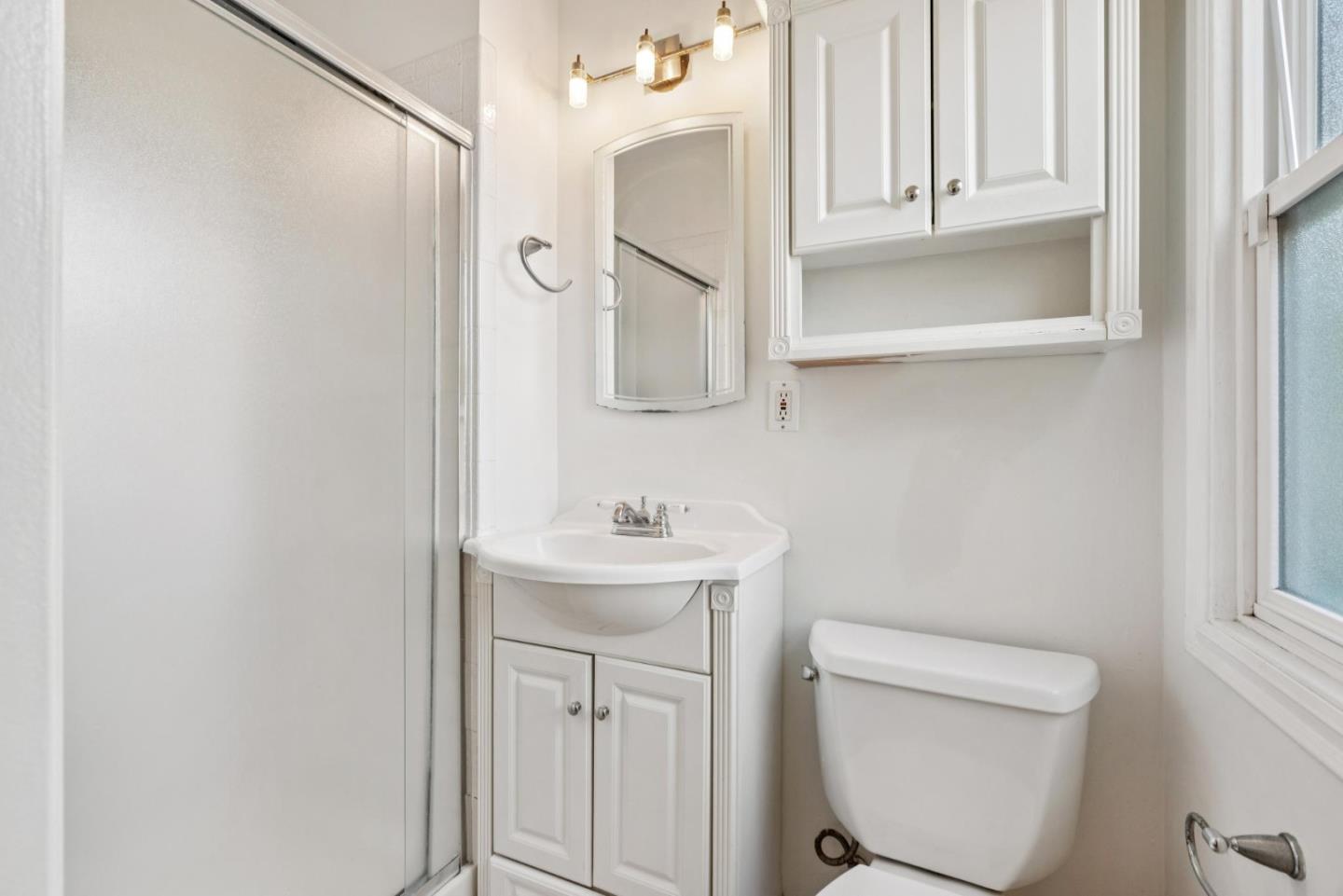3107 Windsor Place Concord, CA 94518 - Photo 12 of 21 a bathroom with a toilet a sink and a mirror
