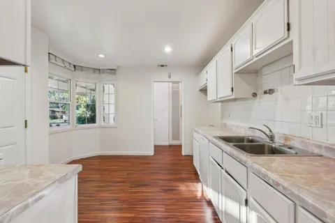 a kitchen with a sink and large window