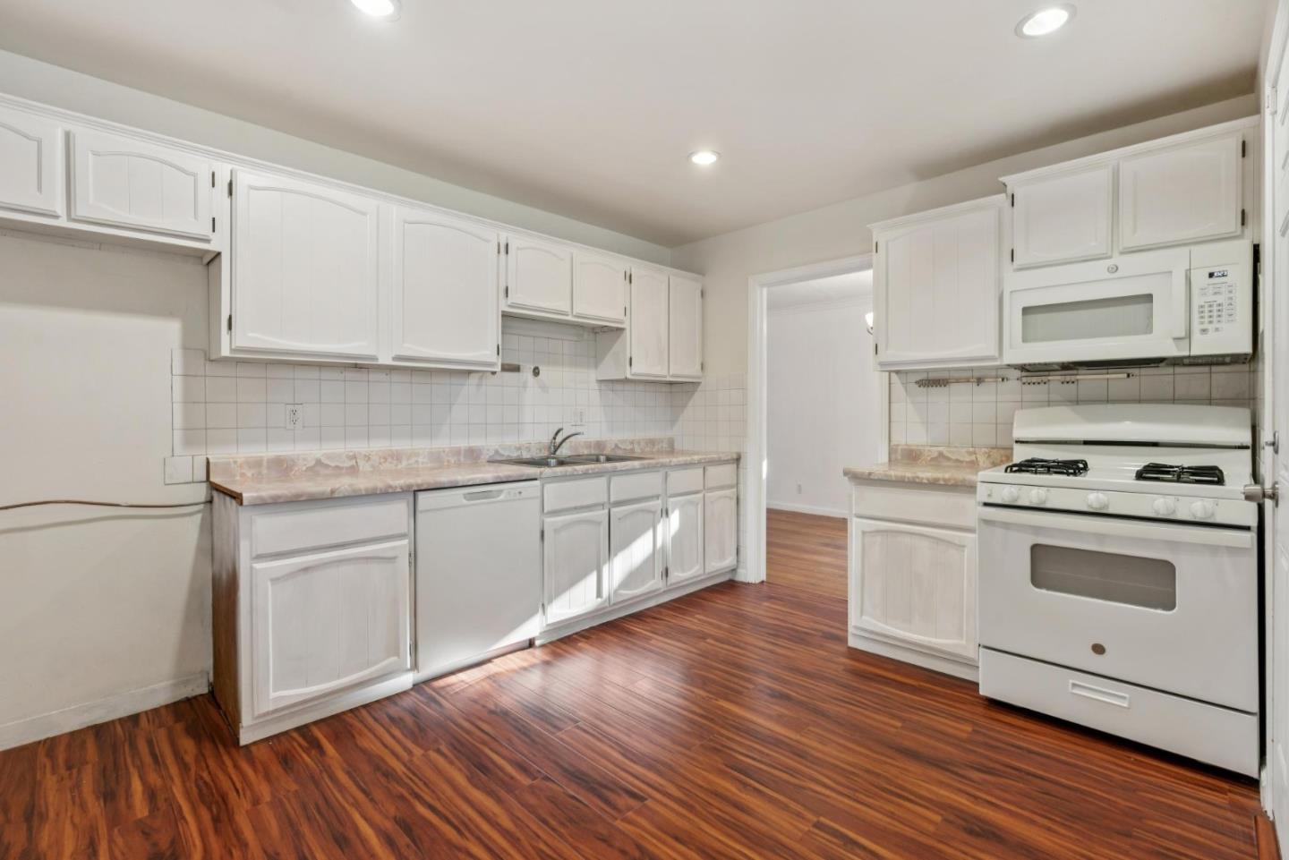3107 Windsor Place Concord, CA 94518 - Photo 9 of 21 a kitchen with granite countertop white cabinets and white appliances