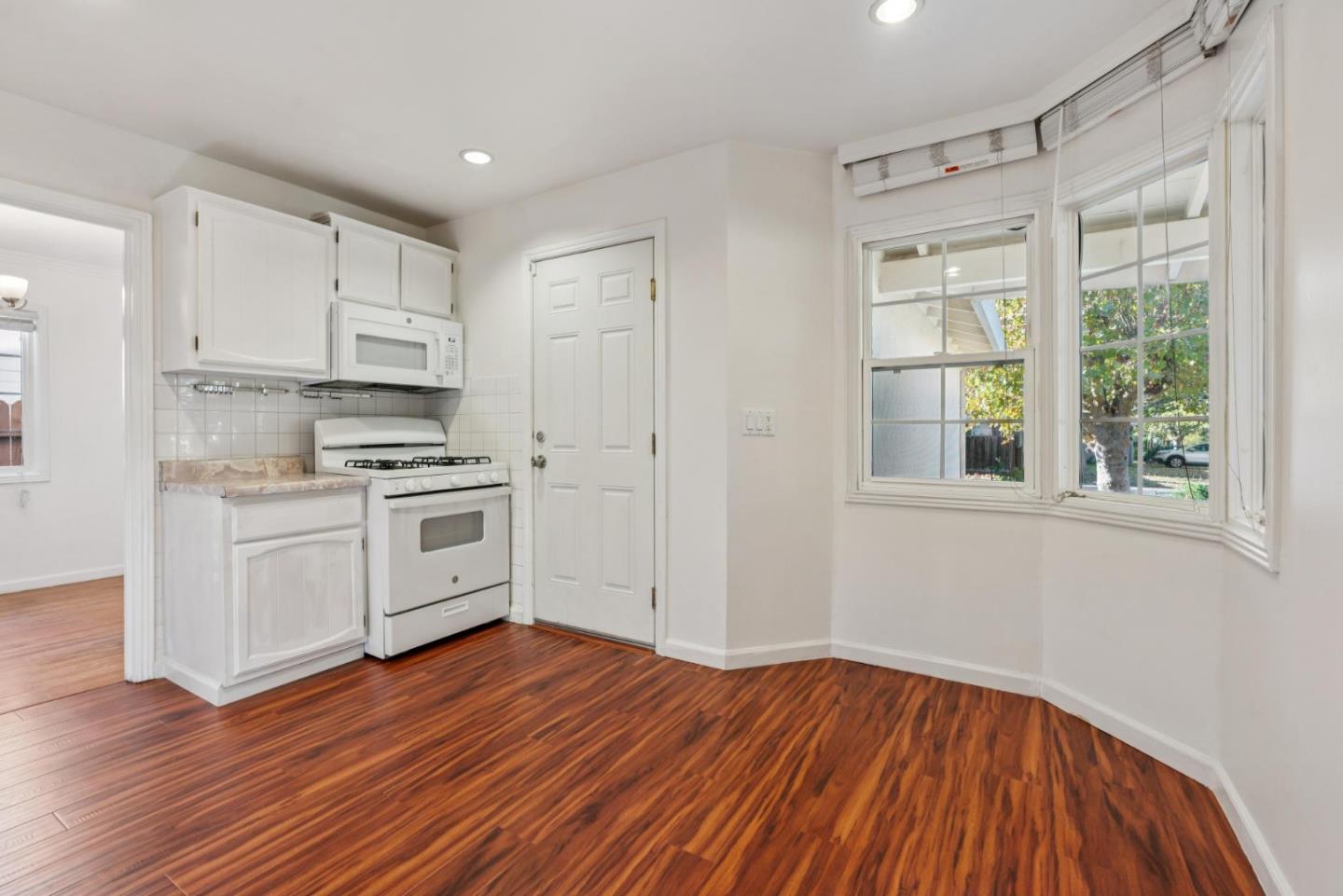 3107 Windsor Place Concord, CA 94518 - Photo 10 of 21 a kitchen with wooden floors and white appliances