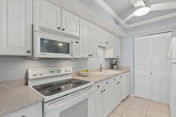 a kitchen with cabinets appliances a sink and a counter top