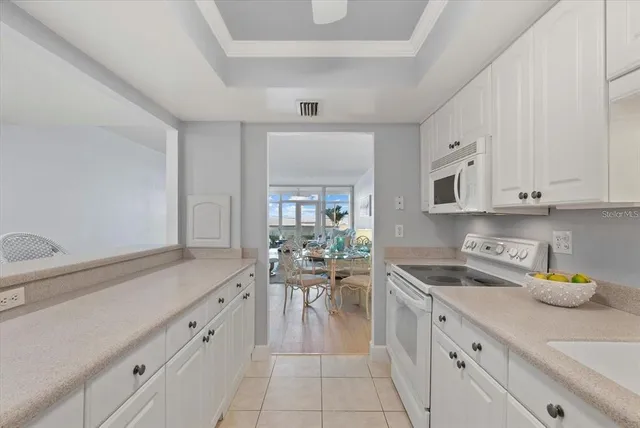 a kitchen with cabinets and window