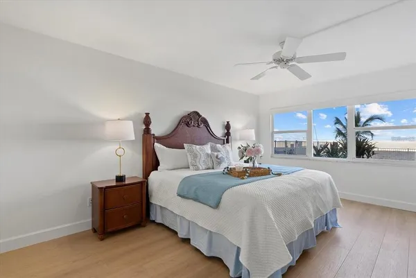 a bedroom with bed and a chandelier