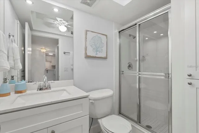 a bathroom with a toilet a sink and glass door
