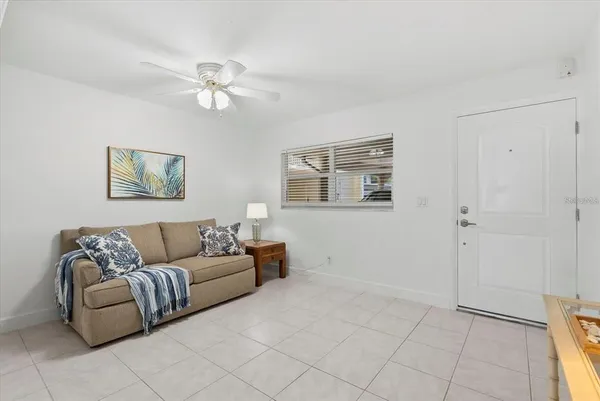 a living room with furniture and a ceiling fan